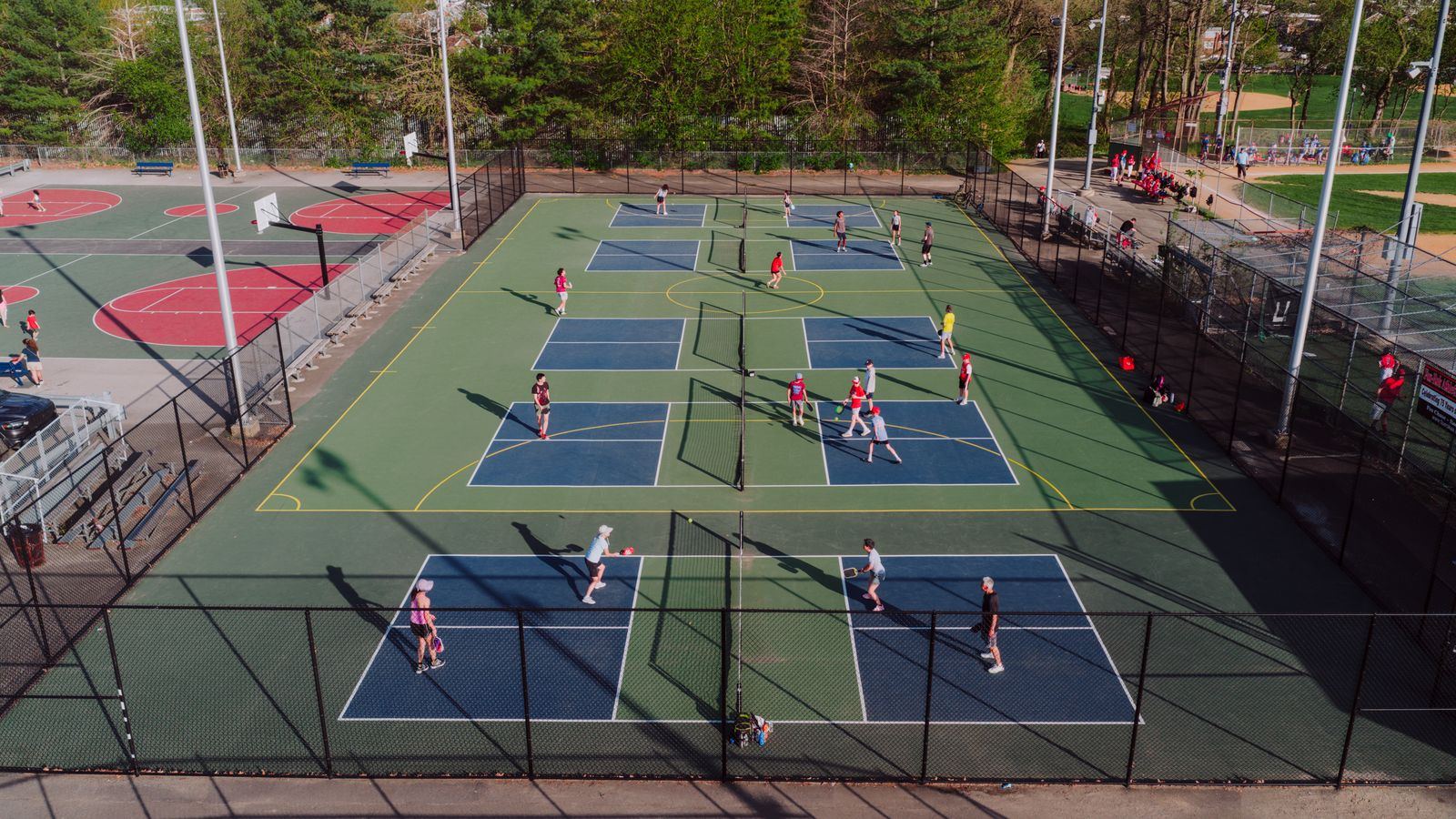 Aerial view of busy outdoor pickleball courts