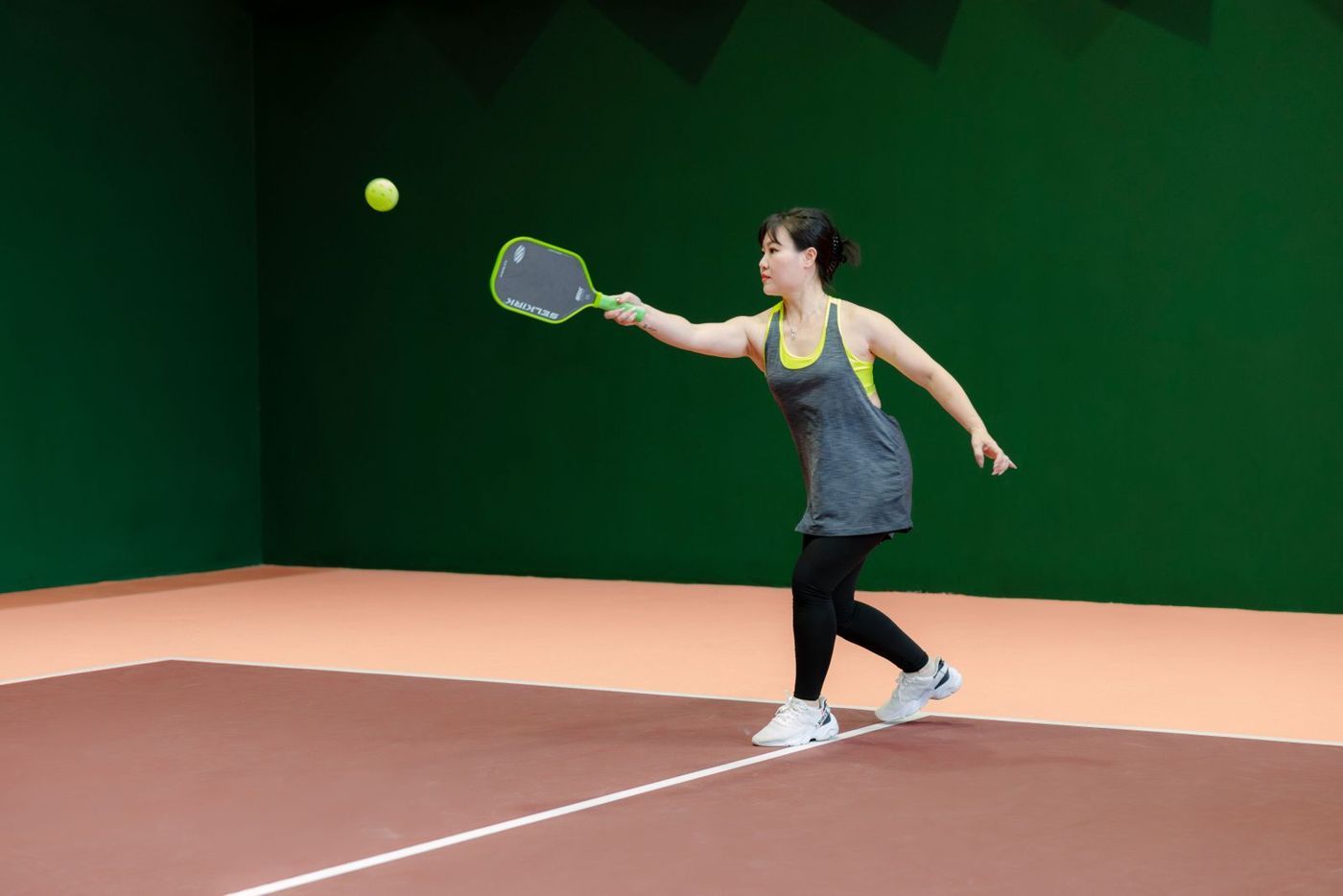 Player reaching for a ball at shoulder height
