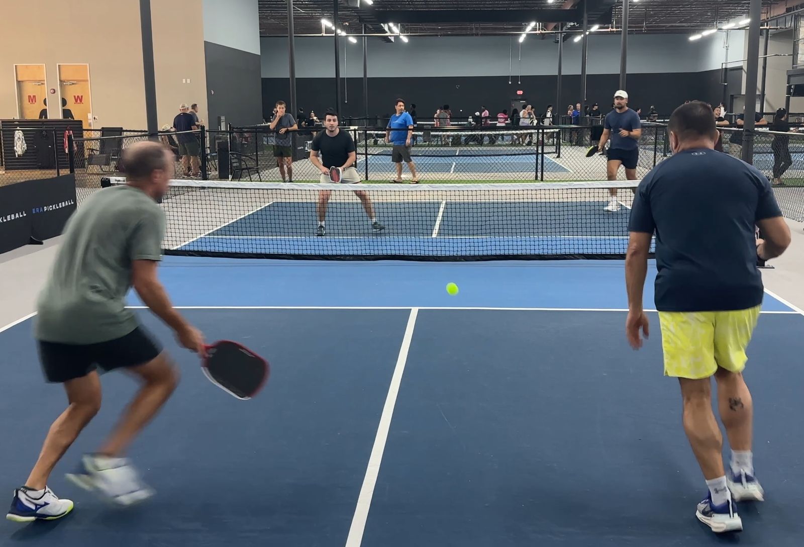 Two doubles players at the net during a rally